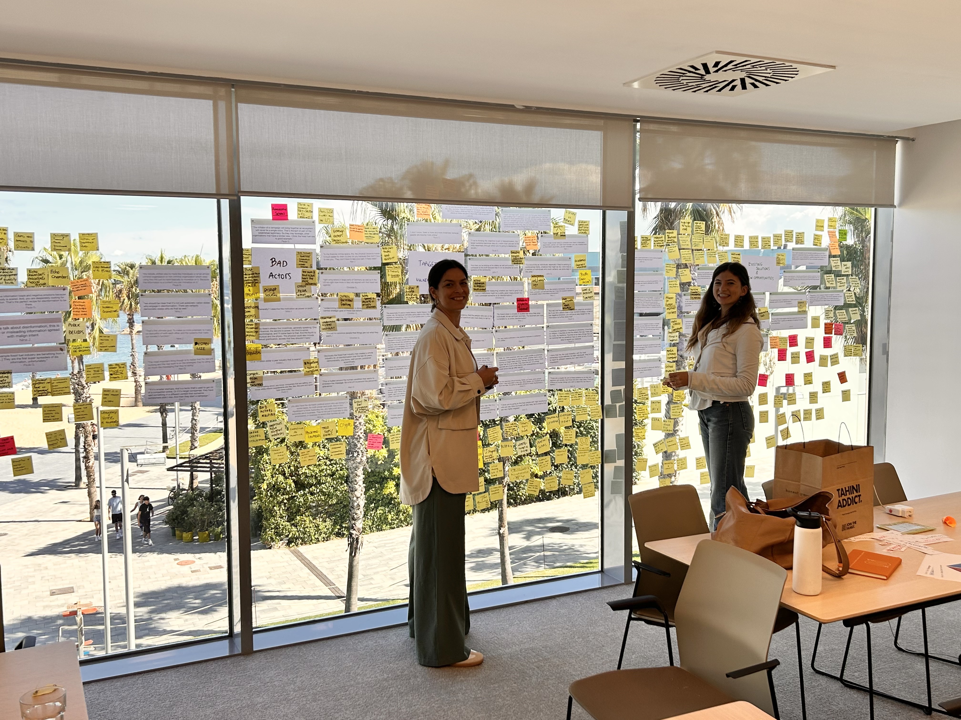 Co-design workshop output on a whiteboard with sticky notes and sketches.